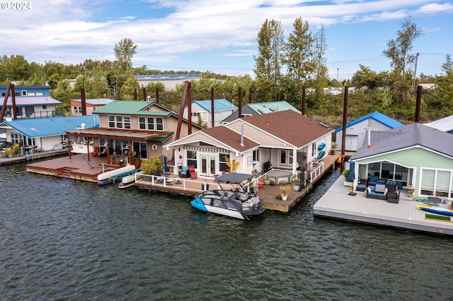 back of property with a water view