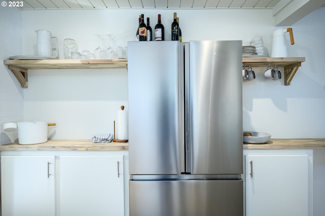 kitchen with butcher block countertops and stainless steel fridge