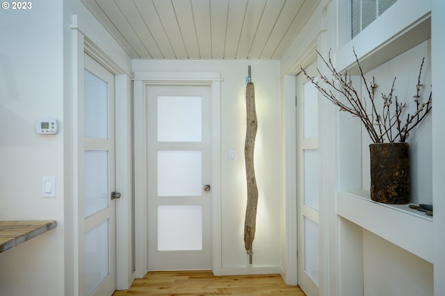 entryway featuring light hardwood / wood-style floors and wood ceiling