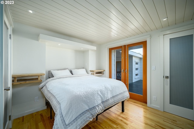 bedroom with french doors and light hardwood / wood-style floors