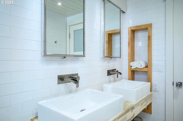 bathroom featuring tile walls and sink