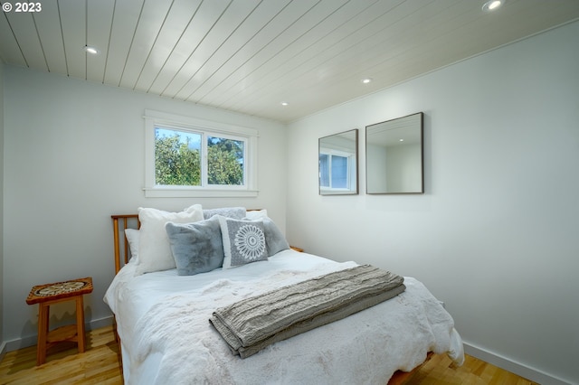 bedroom featuring wooden ceiling and light hardwood / wood-style flooring