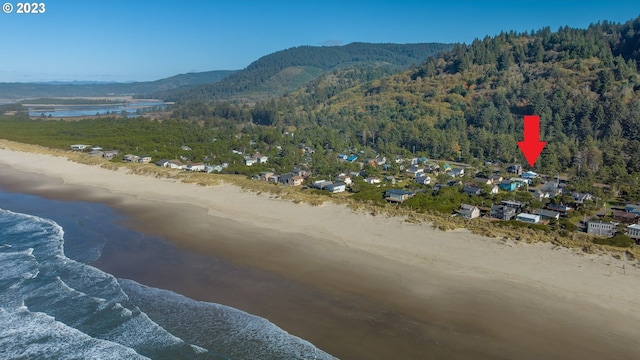 drone / aerial view featuring a water and mountain view