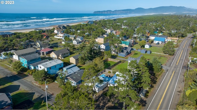 birds eye view of property with a water and mountain view and a view of the beach