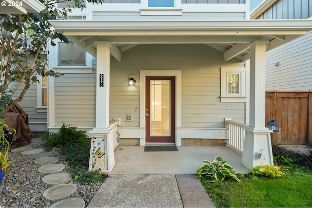 view of exterior entry with fence