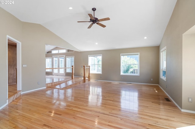 unfurnished living room with ceiling fan, light hardwood / wood-style floors, and vaulted ceiling