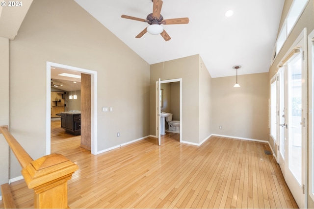 spare room featuring ceiling fan, light hardwood / wood-style flooring, and high vaulted ceiling