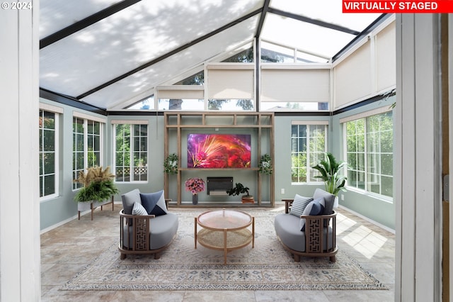 sunroom featuring vaulted ceiling with beams