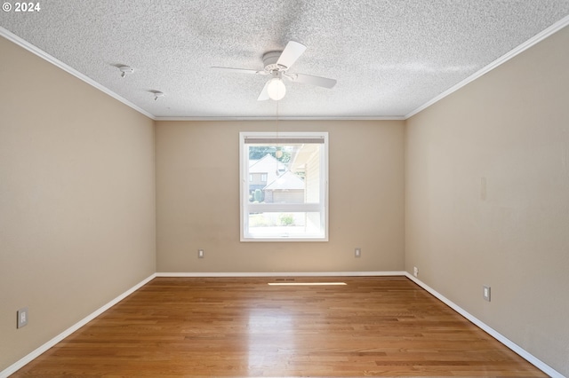 spare room featuring ceiling fan, hardwood / wood-style floors, crown molding, and a textured ceiling