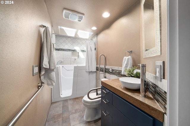 full bathroom featuring vanity, tasteful backsplash, toilet, and separate shower and tub