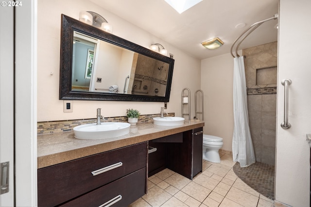 bathroom featuring a shower with shower curtain, tile patterned floors, vanity, and toilet