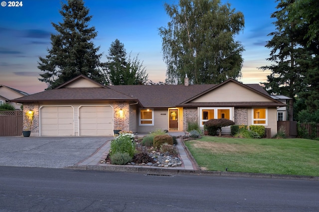 single story home with a lawn and a garage