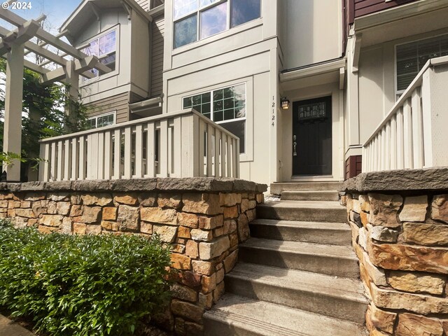 entrance to property with a pergola