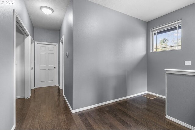 corridor with dark hardwood / wood-style floors