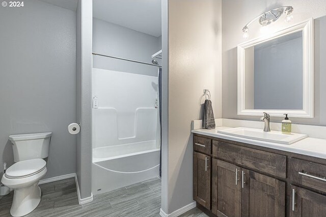 full bathroom with shower / bathing tub combination, vanity, and toilet