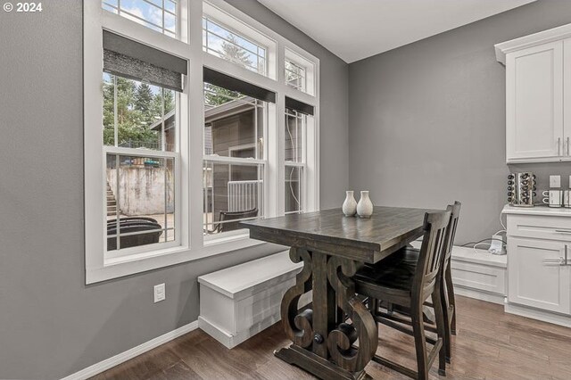 dining area featuring dark wood-type flooring