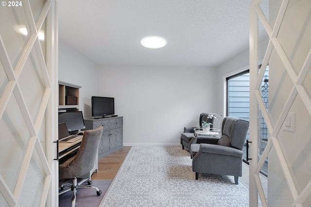 office space with wood-type flooring