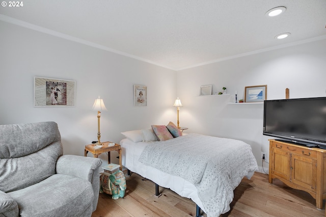 bedroom featuring crown molding and light wood-type flooring