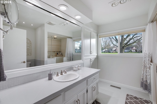 bathroom featuring vanity, tile patterned floors, toilet, and a bathing tub