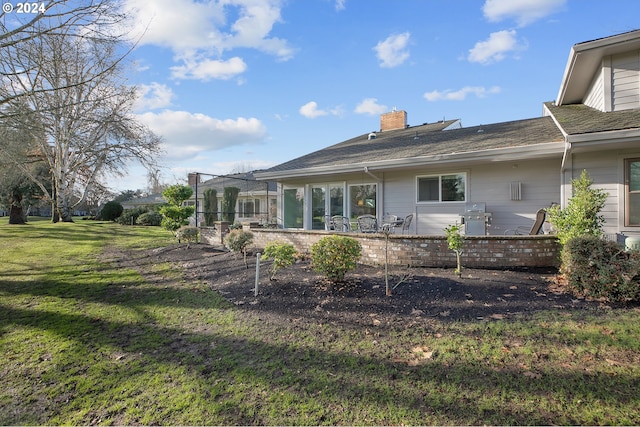 back of house featuring a yard and a patio