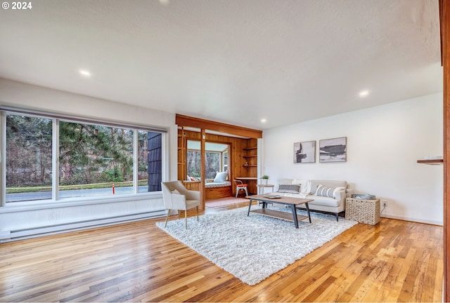 living room featuring a baseboard radiator and light hardwood / wood-style floors