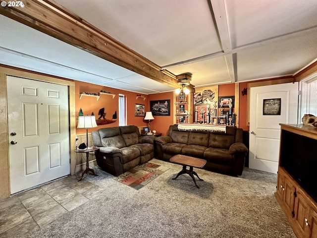 carpeted living room with beamed ceiling