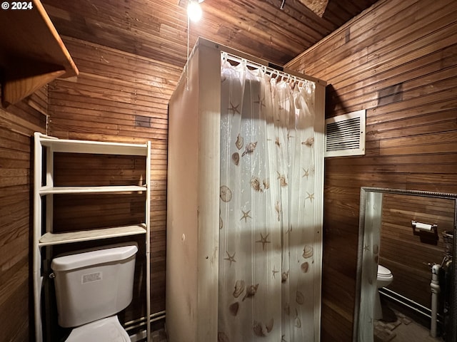 bathroom with wooden ceiling, toilet, and wood walls