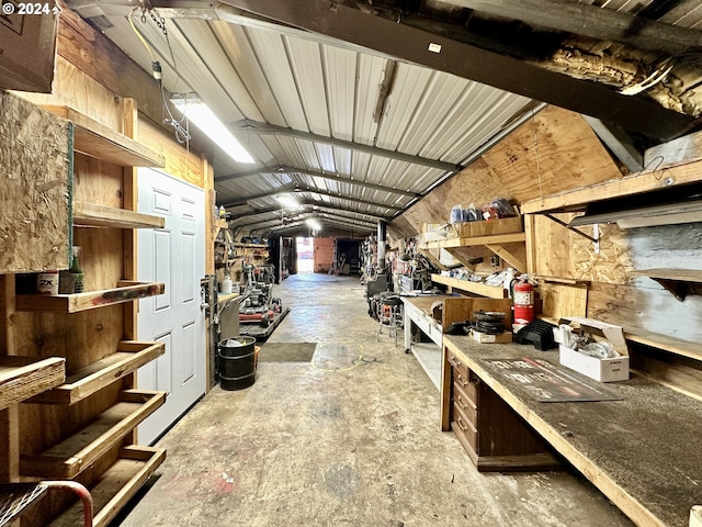 interior space with lofted ceiling and a workshop area