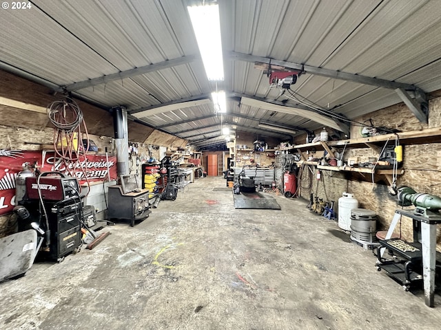 garage with a garage door opener and a workshop area