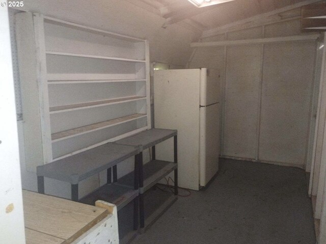 basement with white fridge