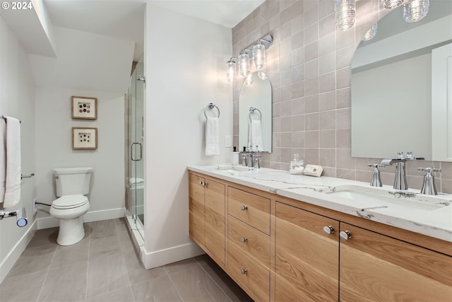 bathroom with vanity, tile patterned floors, decorative backsplash, toilet, and an enclosed shower