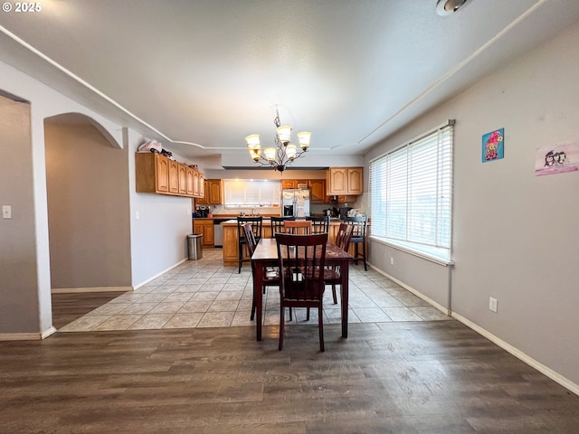 dining room featuring a chandelier and light wood-type flooring