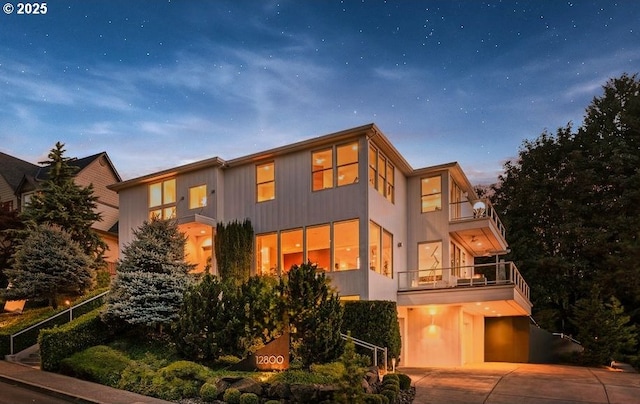 exterior space featuring driveway, a balcony, and an attached garage