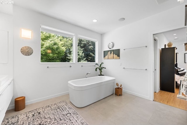 bathroom with a bathing tub and wood-type flooring