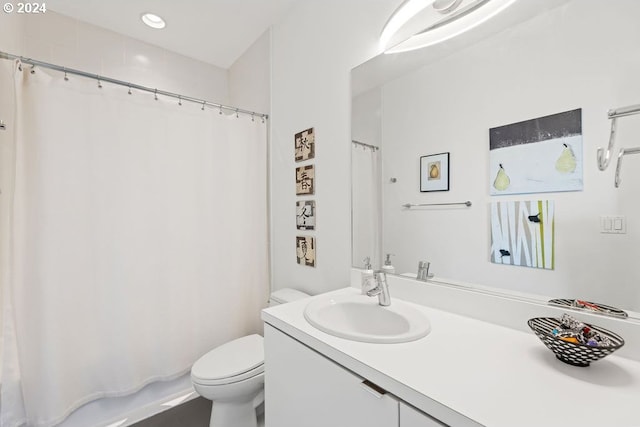 bathroom with vanity, toilet, and a shower with curtain