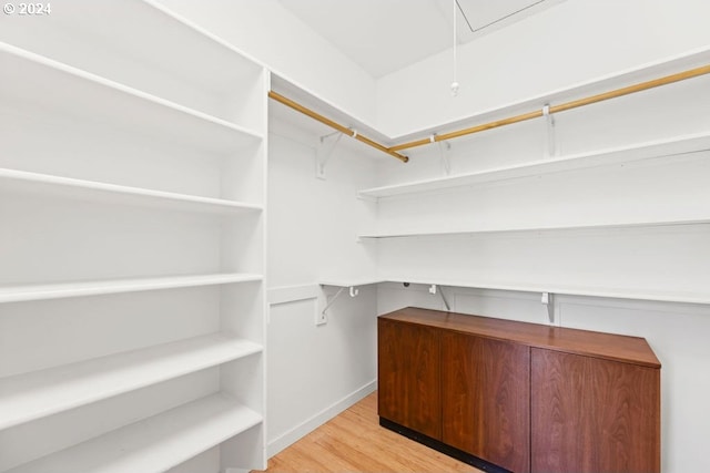 walk in closet featuring light hardwood / wood-style floors