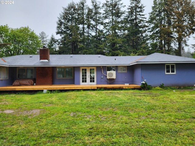 43460 Nicholson Dr, Port Orford, OR 97465 - rear view of house with french doors, a chimney, a deck, and a yard