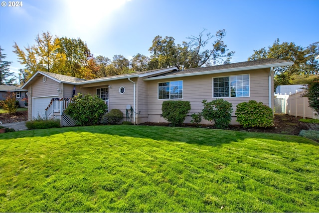 ranch-style home featuring a garage and a front lawn