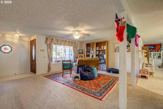 interior space with carpet, a textured ceiling, and ceiling fan