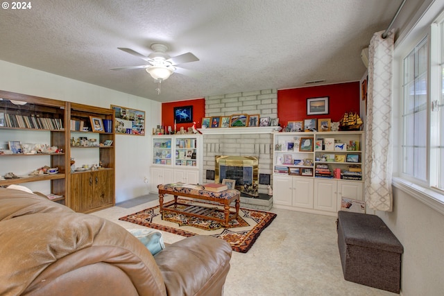 carpeted living room with a fireplace, a textured ceiling, and ceiling fan