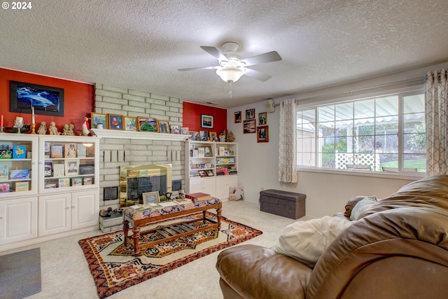 living room featuring a fireplace, a textured ceiling, and carpet flooring