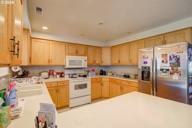 kitchen featuring white appliances, a textured ceiling, sink, and backsplash