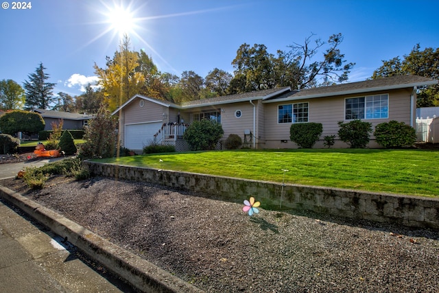 ranch-style home with a garage and a front yard