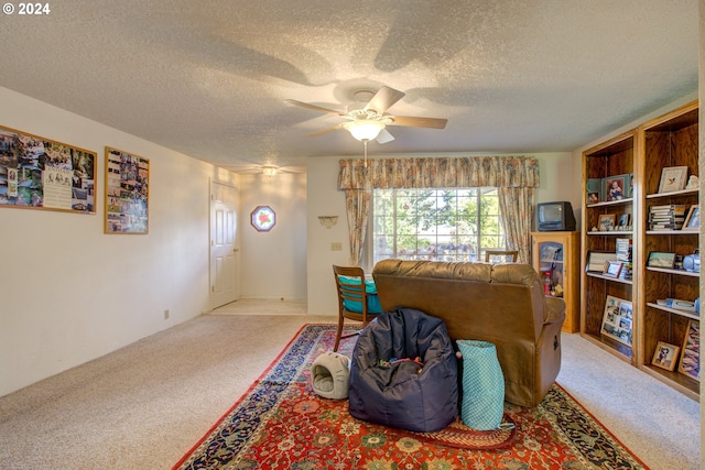 carpeted living room with a textured ceiling and ceiling fan