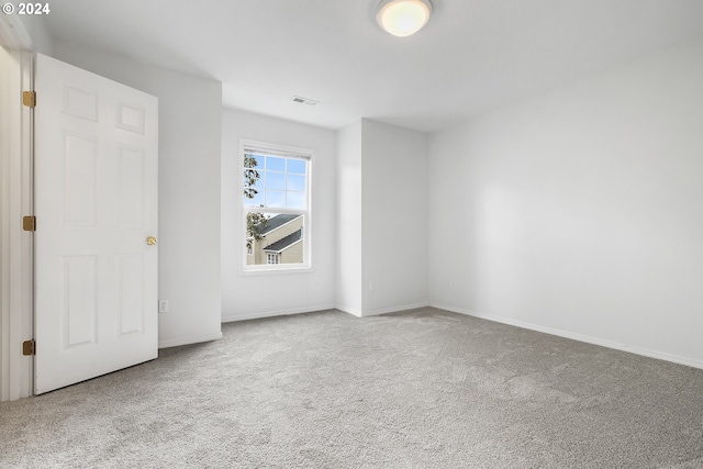 empty room featuring light colored carpet