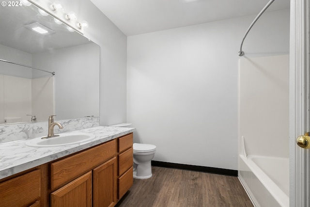 full bathroom with shower / bathing tub combination, hardwood / wood-style floors, vanity, and toilet