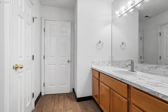 bathroom featuring hardwood / wood-style floors and vanity