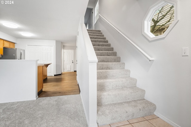 staircase with wood-type flooring