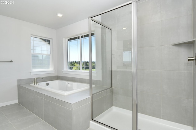 bathroom with tile flooring and plus walk in shower