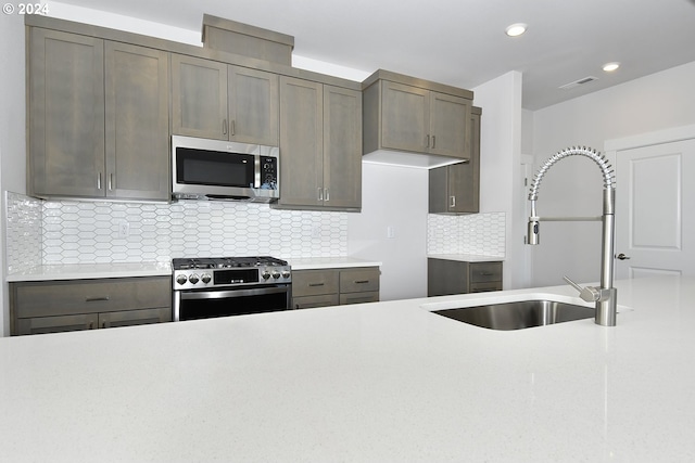 kitchen featuring sink, backsplash, and stainless steel appliances